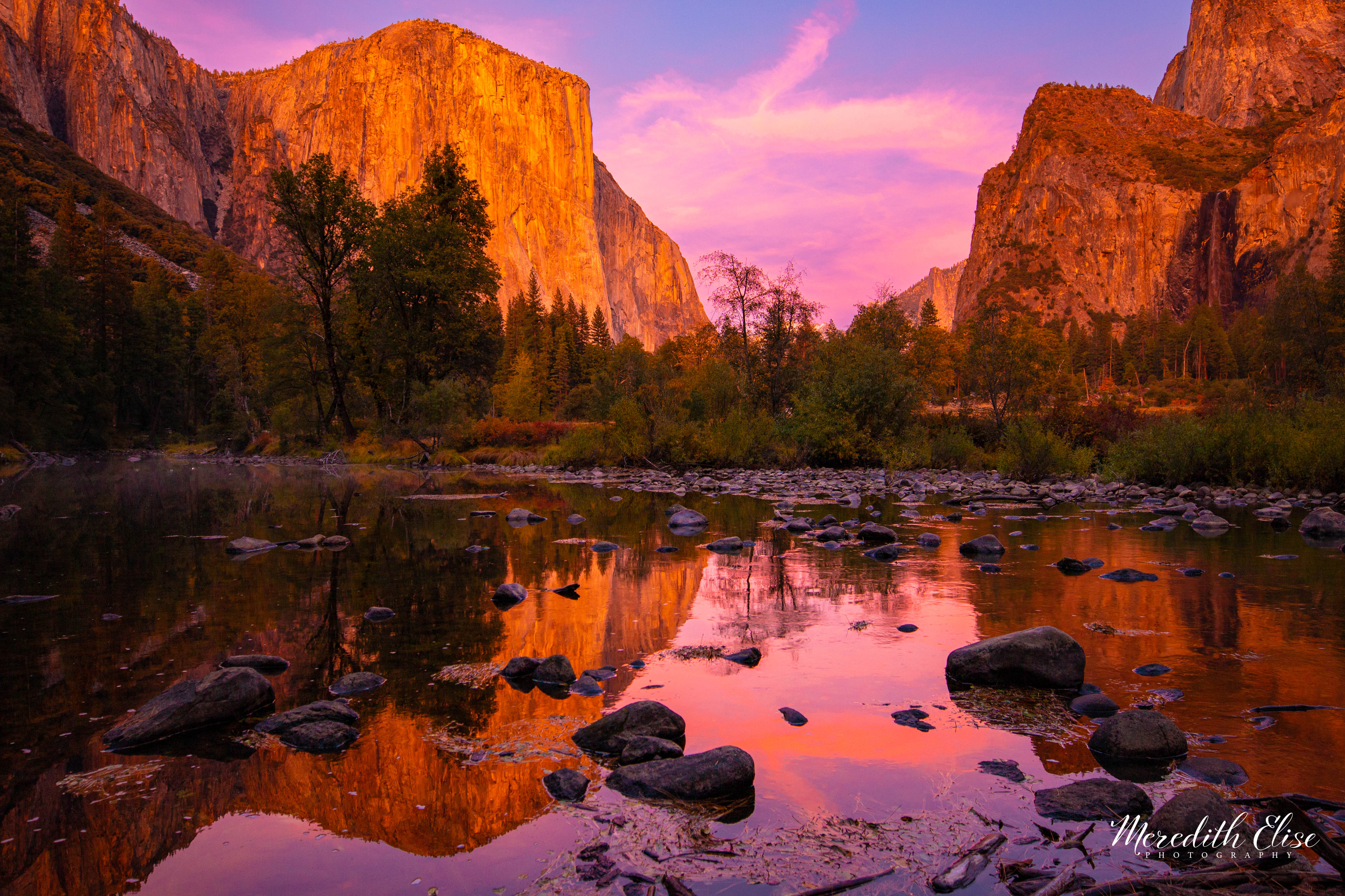 Valley View at Yosemite ablaze with pink and orange alpenglow at sunset